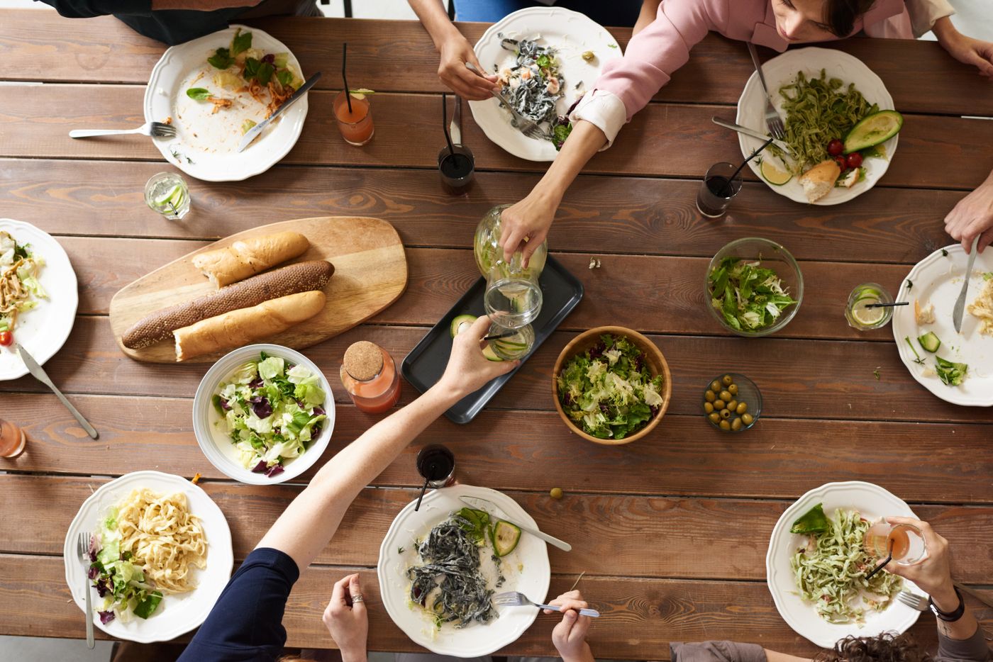 Hands and plates on the shared table
